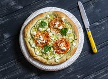 Pizza With Zucchini, Tomatoes, Onions And Feta Cheese On A Light Board On Dark Wooden Background. Royalty Free Stock Photo Pizza With Zucchini, Tomatoes, Onions And Feta Cheese On A Light Board On Dark Wooden Background. Royalty Free Stock Photo