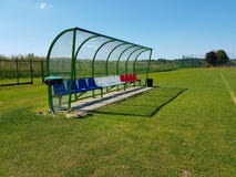 Places for coaches and reserve players on the football field. Plastic colored benches under a canopy of transparent fiberglass. Re royalty free stock photography Places for coaches and reserve players on the football field. Plastic colored benches under a canopy of transparent fiberglass. Re royalty free stock photography
