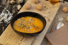 Plate of pumpkin soup on wooden cutting board royalty free stock image Plate of pumpkin soup on wooden cutting board royalty free stock image
