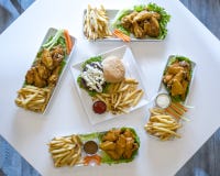 Platters of chicken wings, cheeseburgers, and french fries stock image Platters of chicken wings, cheeseburgers, and french fries stock image