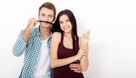 Playful couple fooling on valentine day. Beautiful young loving couple bonding to each other and smiling while making a stock images Playful couple fooling on valentine day. Beautiful young loving couple bonding to each other and smiling while making a stock images