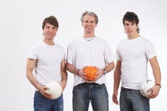 Playful men. Three men in a row holding three balls Playful men. Three men in a row holding three balls