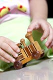 Playing With A Wooden Train Toy Stock Photography