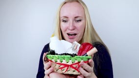 A man gives a beautiful girl a gift - a basket with cosmetics and hygiene products. Pleasant surprise for Birthday, Valentine`s Da. Pleasant surprise for A man gives a beautiful girl a gift - a basket with cosmetics and hygiene products. Pleasant surprise for Birthday, Valentine`s Da. Pleasant surprise for