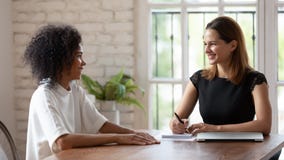 HR manager holding job interview with skilled african ethnicity woman.