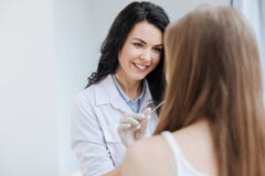 Pleasant young pediatrician examining teenager health in the hospital stock photos Pleasant young pediatrician examining teenager health in the hospital stock photos