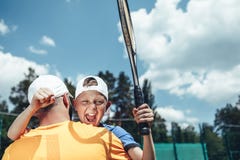 Pleased child hugging dad after tennis game stock images Pleased child hugging dad after tennis game stock images