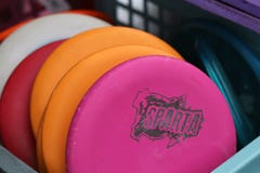 Plenty of Colorful Frisbee Golf Disc in a Basket