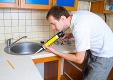 Plumber Putting A Silicone Sealant Royalty Free Stock Images Plumber Putting A Silicone Sealant Royalty Free Stock Images