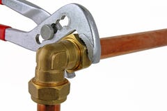 Plumber`s red handled adjustable wrench tightening up copper pipework royalty free stock images Plumber`s red handled adjustable wrench tightening up copper pipework royalty free stock images