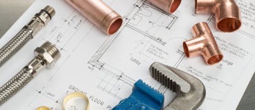 Plumbers Tools and Plumbing Materials Banner on House Plans Stock Photography Plumbers Tools and Plumbing Materials Banner on House Plans Stock Photography