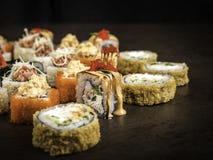 Plusieurs différents petits pains dans le style japonais sur une surface foncée, vue de côté, avec le foyer sélectif image stock Plusieurs différents petits pains dans le style japonais sur une surface foncée, vue de côté, avec le foyer sélectif image stock