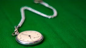 Pocket Watch with chain on green background stock photography Pocket Watch with chain on green background stock photography