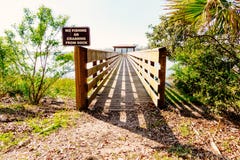 Point of view shot of a wooden dock with a sign that reads stock photo Point of view shot of a wooden dock with a sign that reads stock photo