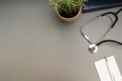 Points, a stethoscope and a notebook on a gray background, the working place of the doctor stock photo Points, a stethoscope and a notebook on a gray background, the working place of the doctor stock photo