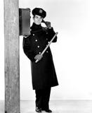 Police officer holding a nightstick and talking on a phone royalty free stock images Police officer holding a nightstick and talking on a phone royalty free stock images