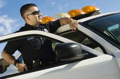 Police Officer Leaning On Patrol Car Stock Photography Police Officer Leaning On Patrol Car Stock Photography