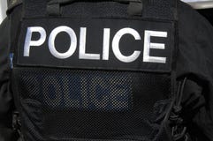 POLICE officer logo on SWAT officers vest.