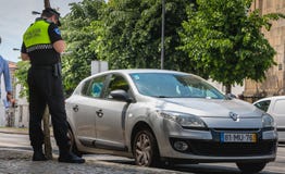Policeman checks and writes a traffic ticket stock photos