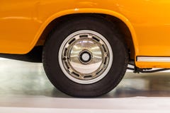 Polished car rim with black vintage wheel on orange car stock images Polished car rim with black vintage wheel on orange car stock images