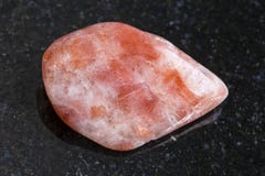 polished sunstone (heliolite) gemstone on dark royalty free stock image polished sunstone (heliolite) gemstone on dark royalty free stock image