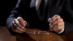 Political official holding eyeglasses while thinking over important decision royalty free stock images Political official holding eyeglasses while thinking over important decision royalty free stock images