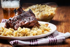 Pork knuckle with fried sauerkraut and baked potatoes Royalty Free Stock Photography Pork knuckle with fried sauerkraut and baked potatoes Royalty Free Stock Photography