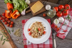 Porridge with vegetables in Italian. Risotto with vegetables. Still life with a dish and fresh vegetables on a wooden background. stock image Porridge with vegetables in Italian. Risotto with vegetables. Still life with a dish and fresh vegetables on a wooden background. stock image