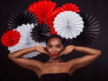 Portrait, African woman and smile with origami on hair in studio background for fashion, art and decor. Female person