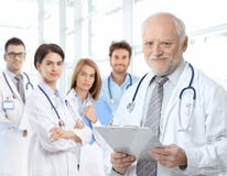 Portrait of aged doctor with medical residents royalty free stock images Portrait of aged doctor with medical residents royalty free stock images
