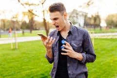 Portrait of an angry young man screaming on his mobile phone out stock photography Portrait of an angry young man screaming on his mobile phone out stock photography