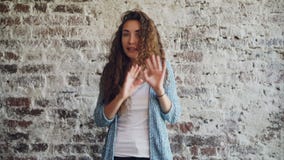Portrait of angry young woman talking and gesturing expressing negative emotions standing indoors with loft style stock video footage Portrait of angry young woman talking and gesturing expressing negative emotions standing indoors with loft style stock video footage