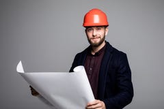 Portrait of an architect builder studying layout plan of the rooms, serious civil engineer working with documents on construction Stock Photo Portrait of an architect builder studying layout plan of the rooms, serious civil engineer working with documents on construction Stock Photo