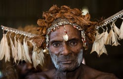 The Portrait Asmat warrior with a traditional painting and coloring on a face.