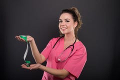 Portrait of attractive lady doctor holding measuring tape Royalty Free Stock Photography Portrait of attractive lady doctor holding measuring tape Royalty Free Stock Photography