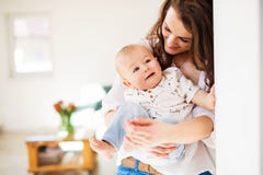 Portrait of a young mother with a baby son at home. Copy space. royalty free stock photos Portrait of a young mother with a baby son at home. Copy space. royalty free stock photos