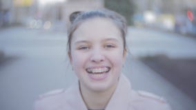 Portrait of an attractive young teen girl looking at the camera and smiling. Close shot stock video Portrait of an attractive young teen girl looking at the camera and smiling. Close shot stock video