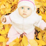 Portrait of baby at autumn park with yellow leaves background royalty free stock images Portrait of baby at autumn park with yellow leaves background royalty free stock images