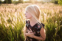 Portrait of a baby girl spinning in a field in sunset light Royalty Free Stock Photography Portrait of a baby girl spinning in a field in sunset light Royalty Free Stock Photography