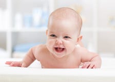 Portrait of baby lying on her belly stock image Portrait of baby lying on her belly stock image