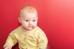 Portrait of a baby on a red background, newborn girl close-up in the studio stock image Portrait of a baby on a red background, newborn girl close-up in the studio stock image