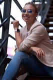 Portrait of beautiful casual attractive woman on steel stairs at back yard. royalty free stock photos Portrait of beautiful casual attractive woman on steel stairs at back yard. royalty free stock photos