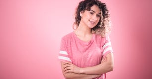 Portrait of a beautiful cheerful girl with curly hair on a pink background royalty free stock photography Portrait of a beautiful cheerful girl with curly hair on a pink background royalty free stock photography