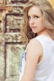 Portrait of beautiful girl with full lips in a white t-shirt standing on the street near the old building stock photography Portrait of beautiful girl with full lips in a white t-shirt standing on the street near the old building stock photography