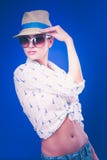 Portrait of beautiful model in hat with glasses ,isolated on blue background stock images Portrait of beautiful model in hat with glasses ,isolated on blue background stock images
