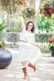 Portrait of beautiful smiling white Caucasian girl woman with long dark red brown hair, in white summer dress stock photo Portrait of beautiful smiling white Caucasian girl woman with long dark red brown hair, in white summer dress stock photo