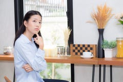 Portrait of beautiful young asian woman happiness and think sitting at cafe shop royalty free stock photo Portrait of beautiful young asian woman happiness and think sitting at cafe shop royalty free stock photo