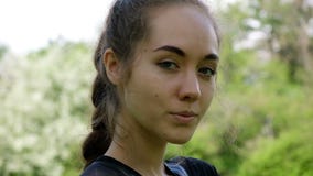 Portrait of a beautiful young girl, slow motion. European model woman model posing and turning on camera. stock video Portrait of a beautiful young girl, slow motion. European model woman model posing and turning on camera. stock video