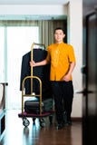Portrait of Asian bell boy pulling box van royalty free stock image Portrait of Asian bell boy pulling box van royalty free stock image