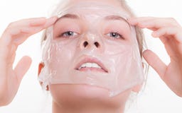 Portrait blond girl in facial mask. Beauty and skin care. Stock Image Portrait blond girl in facial mask. Beauty and skin care. Stock Image